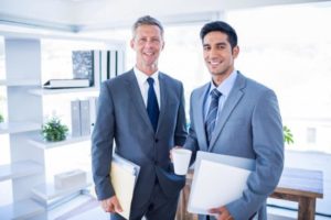 two businessmen holding files
